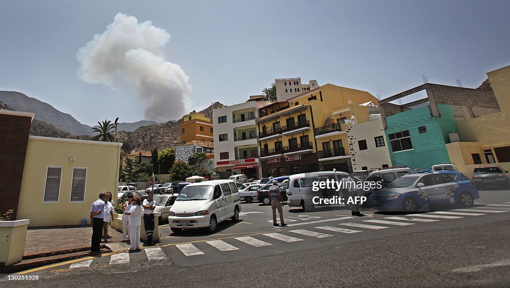 Smoke rises behind the village of Valleh