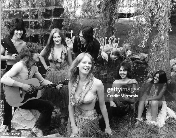 Edison Lighthouse release their new record Hawaiian Island. They are pictured with hula girls wearing straw dresses and flowers around their necks....