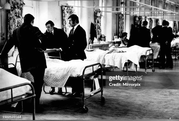 Rangers players visit injured in hospital, January 1971. Pictured - Willie Mathieson and John Greig visit injured in hospital bed in ward at Victoria...