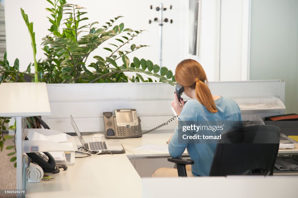 Woman in reception talking on phone