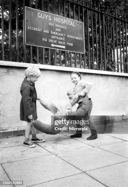 Children play outside Guys Hospital. 29th October 1970.