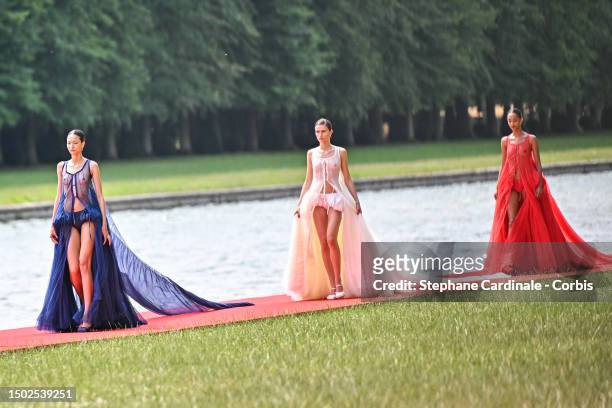 Models walk the runway during "Le Chouchou" Jacquemus' Fashion Show at Chateau de Versailles on June 26, 2023 in Versailles, France.