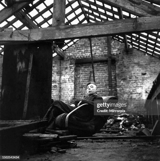 Cyril Eachus seen here leaving his old works building after being evicted by bailiffs. He leaves the works with the Union Jack. And walks away a...