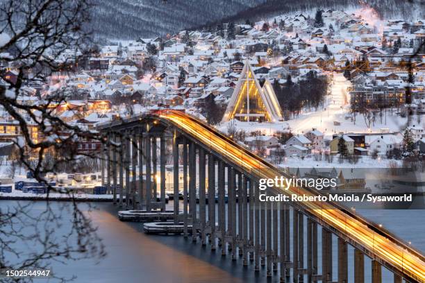 car trails lights on a scenic bridge along a fjord - tromso stock pictures, royalty-free photos & images