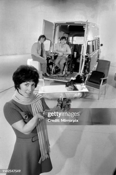 Blue Peter television presenter Val Singleton holds up some of the toy cars which will go towards the next mini-bus appeal. On the children's...