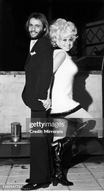 Actress Barbara Windsor and musician Maurice Gibb, of the Bee Gees, joking around at a reception for the musical Sing a Rude Song at the Robert...