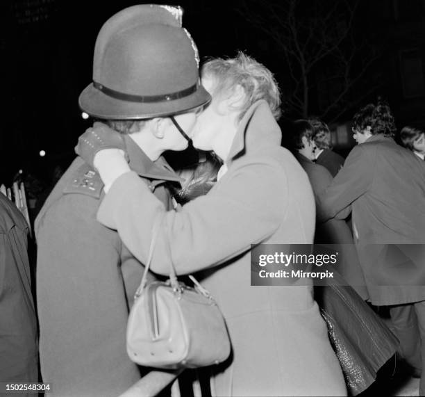 Woman kisses a policemen to celebrate New Year in Albert Square, Manchester, in the last moments of the swinging 1960sPicture taken 31st December...