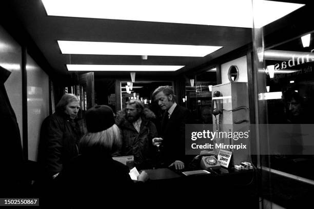 Film legend Michael Caine off-camera with a glass of wine in Godfrey Davies car hire office in Newcastle Central Station during the filming of Get...