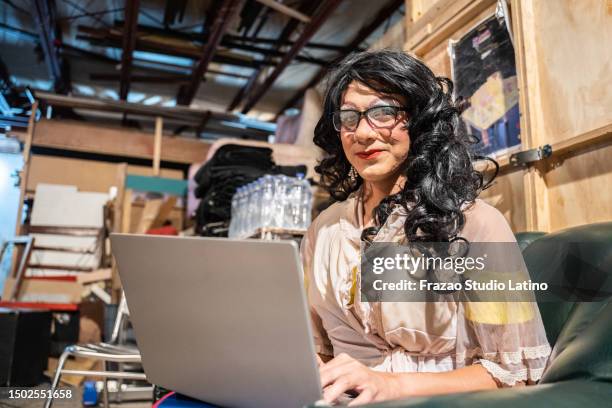 portrait of a drag queen using laptop behind backstage at theater - casting director stock pictures, royalty-free photos & images