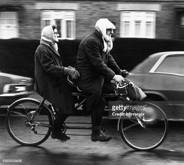 Stanley and Erna Livingstone, riding their tandem bike in Renfrew, Scotland. 20th January 1970.