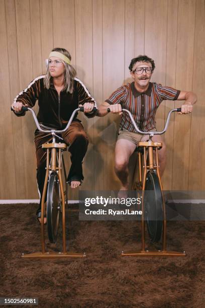retro nineteen eighties aesthetic exercise bike couple - sweet bizarre vintage rides imagens e fotografias de stock