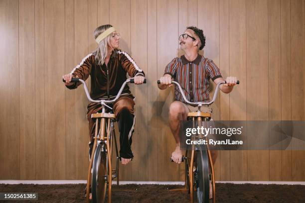 retro nineteen eighties aesthetic exercise bike couple - sweet bizarre vintage rides imagens e fotografias de stock