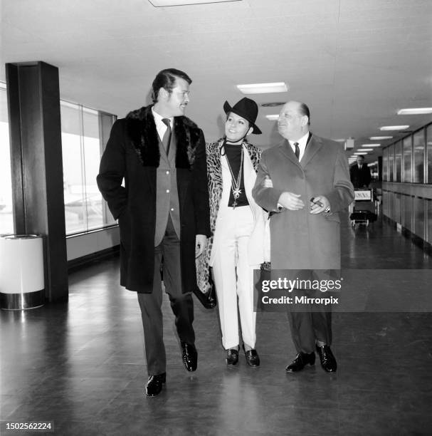 Roger Moore and his wife Luisa leaving Heathrow Airport with Sir Lew Grade for the Monte Carlo Television Festival which was opened by Princess...