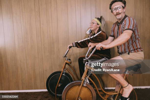 retro nineteen eighties aesthetic exercise bike couple - sweet bizarre vintage rides imagens e fotografias de stock