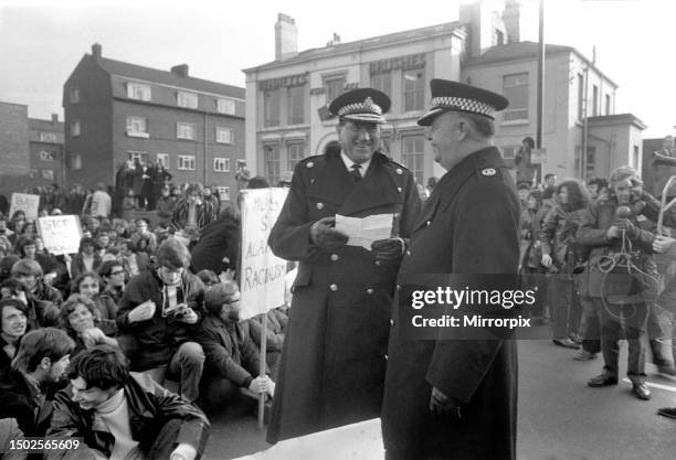 Students demonstration against the Springboks and apartheid system. Chief constable Williams Palfrey rears with lighter as he reads the song sheet...