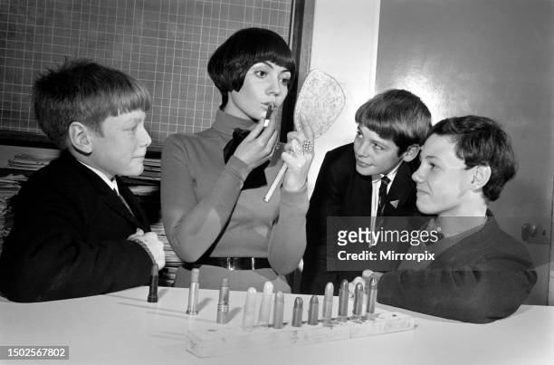 People of Hartford Secondary School. Keith Kay and Philip Robinson look on as model Ann Coates tries one of the lipsticks made during class at the...