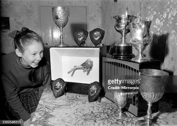 Linda Lloyd with her prize winning 8 month old pied Budgie and the 3 year old bull Finch. December 1969.