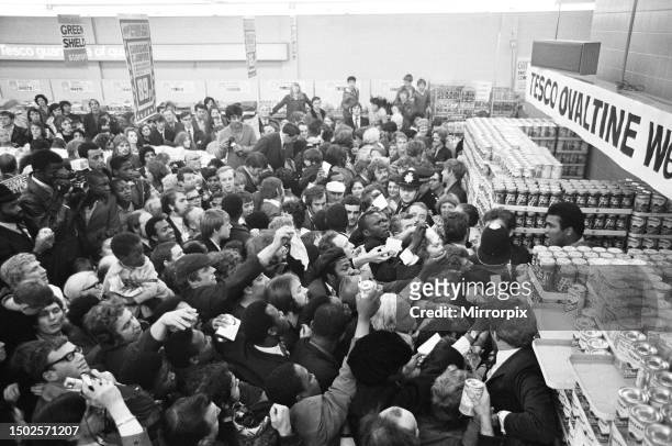 Muhammad Ali at a supermarket in Stretford to promote Ovaltine cornered by loads of fans wanting autographs. Police had to move in to call it off....
