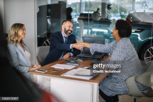 closing the car purchase deal - car insurance stock pictures, royalty-free photos & images