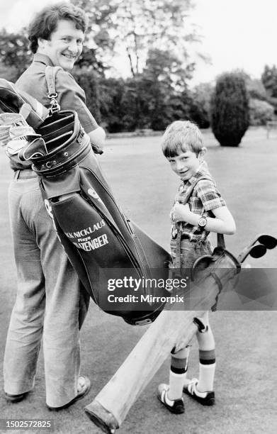 Tom Brennan holds the golf bag containing the clubs Jack Nicklaus used to win the 1966 Open at Muirfield while his son holds two antique clubsCirca...