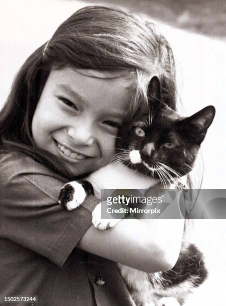 Smiling Carol Riley of Ealing collects her pet cat Cupid after he was released from quarantine from kennels at Hackbridge in Surrey. October 1970.