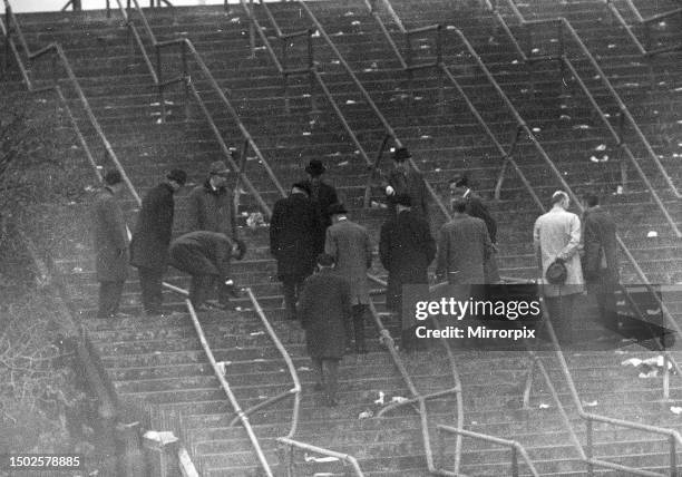 Stairway 13, Ibrox Park, Glasgow, January 1971. Scene of disaster being inspected, with a twisted crush barrier.