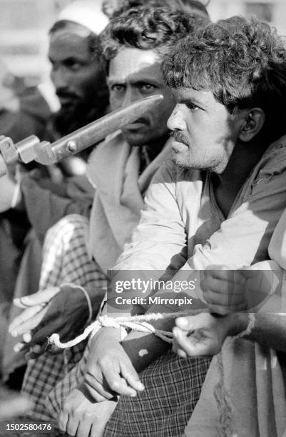 Bangladesh War of Independence 1971. Makti Buhini Freedom Fighters threatening captured Razakar prisoners in Khulna. The prisoners were bound by...