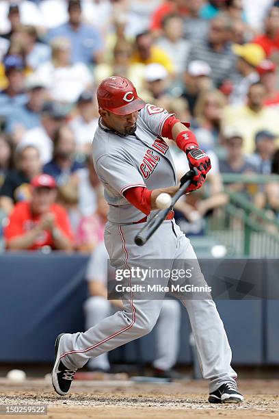 Miguel Cairo of the Cincinnati Reds makes some contact at the plate during the game against the Milwaukee Brewers at Miller Park on August 08, 2012...