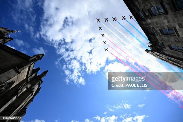The British Royal Air Force's aerobatic team, the "Red Arrows", perform a fly-past over St Giles' Cathedral in Edinburgh on July 5 following a...