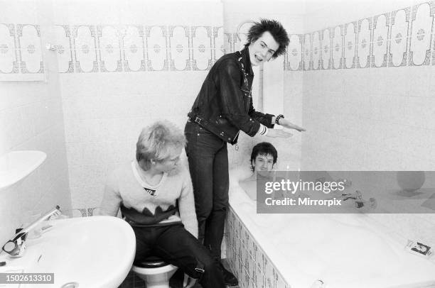 Punk band Sex Pistols relax during their tour of Hollandin the hotel bathroom