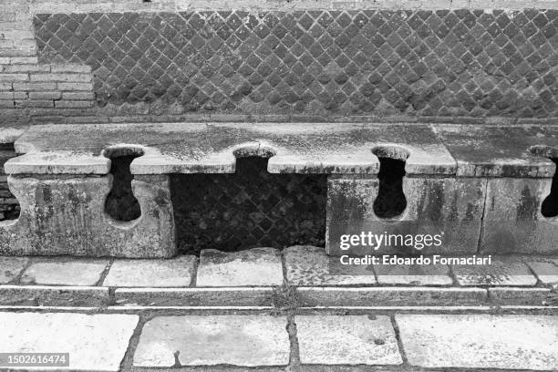 Close-up of latrines in the ruins of the ancient city of Ostia Antica, near Ostia, Italy, February 10, 1987.