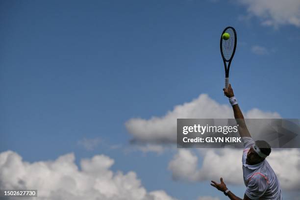 Bulgaria's Grigor Dimitrov serves to Japan's Sho Shimabukuro during their men's singles tennis match on the third day of the 2023 Wimbledon...