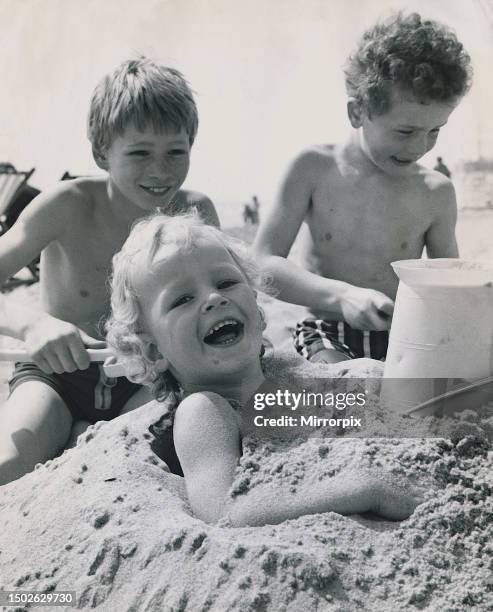 The Hook children are on holiday in Bournemouth their parents from family home in, Bradley Hook seems to enjoy being buried up to his arm-pit in the...
