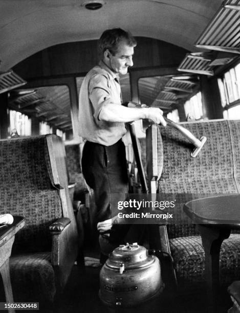 Mr. Frank Baley vacuums seats while cleaning a carriage ready for another journey on 10th September. 1971.