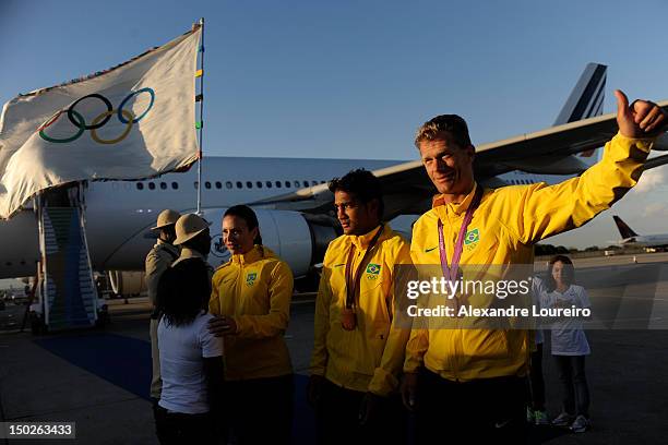 Athletes of Brazil, Robert Schidt, Esquiva Falcao e Maurren Maggi arrive at the international airport of Rio de Janeiro with the Olympic flag on...
