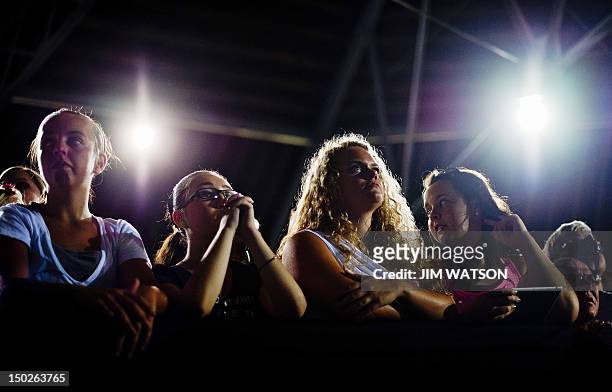 Supporters listen as US President Barack Obama delivers remarks during a campaign event at Herman Park in Boone, Iowa, on August 13, 2012. AFP...