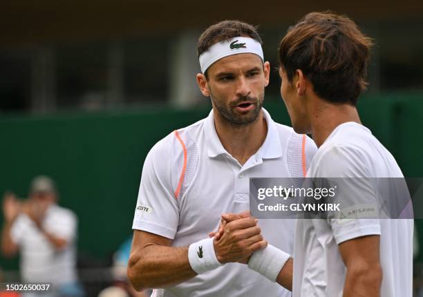 Bulgaria's Grigor Dimitrov shakes hands with Japan's Sho Shimabukuro after winning their men's singles tennis match on the third day of the 2023...