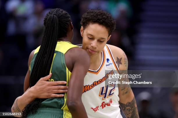 Ezi Magbegor of the Seattle Storm and Brittney Griner of the Phoenix Mercury greet one another before the game at Climate Pledge Arena on June 24,...