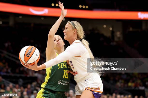 Sophie Cunningham of the Phoenix Mercury shoots against Ivana Dojkic of the Seattle Storm during the first quarter at Climate Pledge Arena on June...