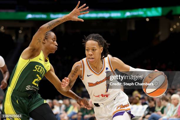 Sug Sutton of the Phoenix Mercury dribbles against Yvonne Turner of the Seattle Storm during the second quarter at Climate Pledge Arena on June 24,...