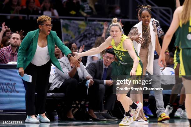 Sami Whitcomb of the Seattle Storm reacts with assistant coach Pokey Chatman and head coach Noelle Quinn during the third quarter against the Phoenix...