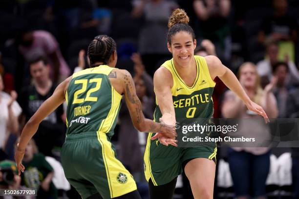 Yvonne Turner and Kia Nurse of the Seattle Storm react after a basket against the Phoenix Mercury during the fourth quarter at Climate Pledge Arena...