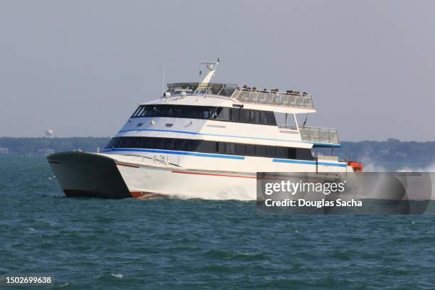 high speed boat moving passengers across the water - ferry terminal stock pictures, royalty-free photos & images