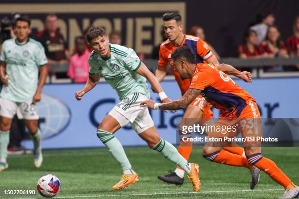 Miguel Berry of Atlanta United FC keeps possession against Alfredo Morales and Tony Alfaro of New York City FC during a game between Atlanta United...