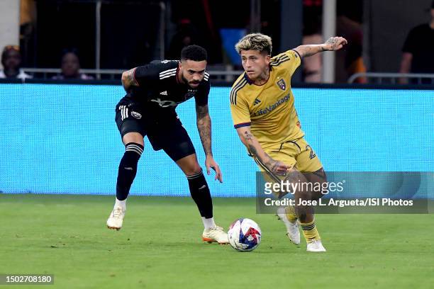Diego Luna of Real Salt Lake battles for the ball with Derrick Williams of D.C. United during a game between Real Salt Lake and D.C. United at Audi...