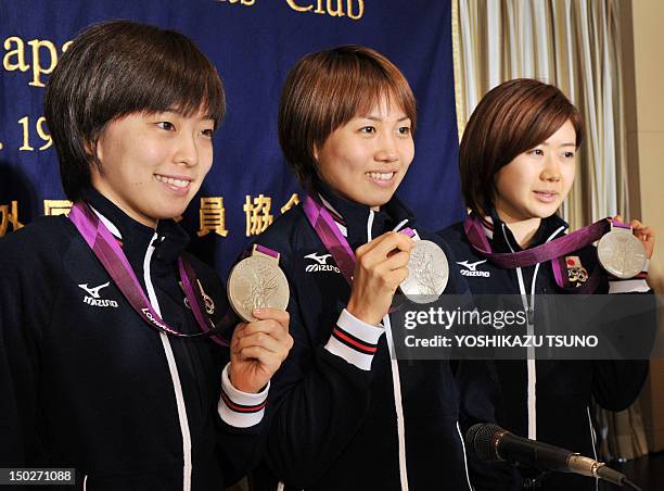 Japan's female table tennis team members Kasumi Ishikawa, Sayaka Hirano and Ai Fukuhara pose with their 2012 London Olympic Games medals before they...