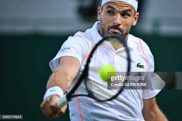 Bulgaria's Grigor Dimitrov returns to Japan's Sho Shimabukuro during their men's singles tennis match on the third day of the 2023 Wimbledon...