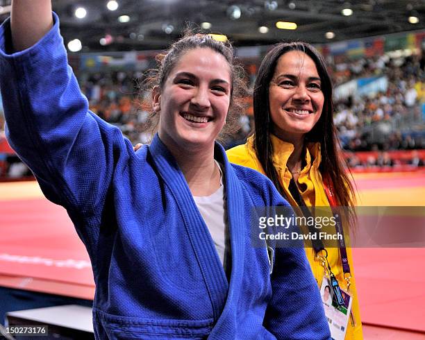 Mayra Aguiar of Brazil and her coach, Rafaela Silva, walk from the mat after winning bronze during the Day 6 u78kgs Women's category at the ExCeL...