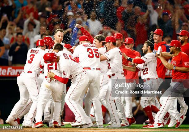 Mike Trout of the Los Angeles Angels celebrates after scoring the game winning run after a wild pitch by Aaron Bummer of the Chicago White Sox at...