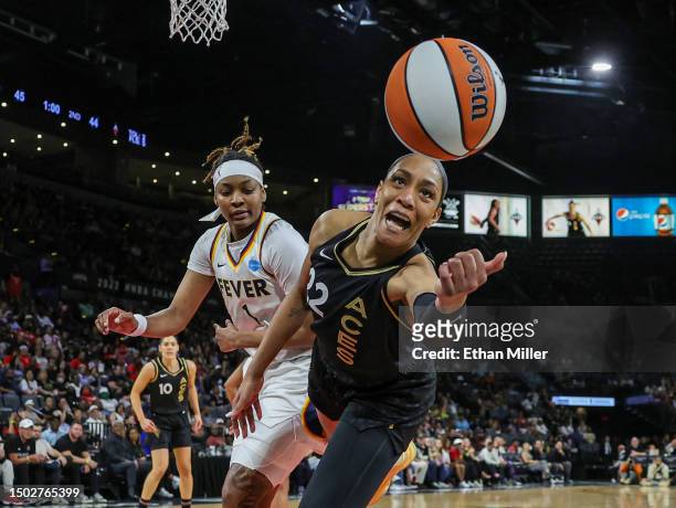 Ja Wilson of the Las Vegas Aces tries to save the ball from going out of bounds as NaLyssa Smith of the Indiana Fever defends in the second quarter...